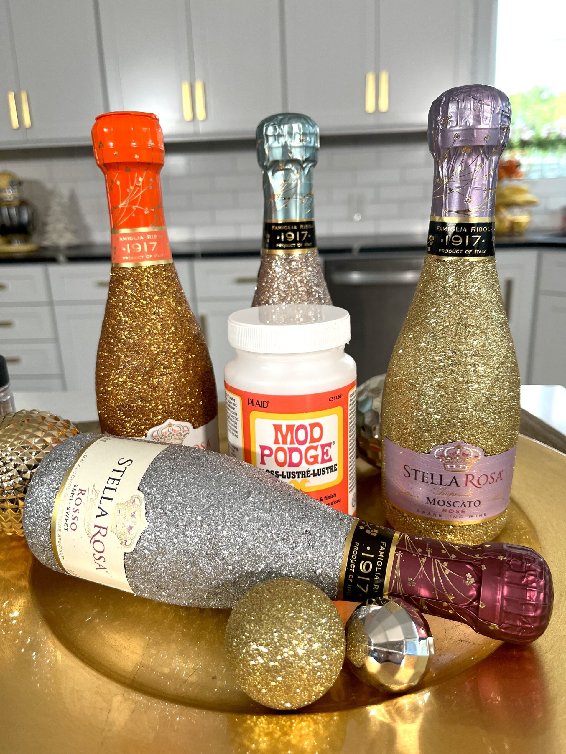 How to Glitter Wine Bottles with Mod Podge - CATHIE FILIAN's